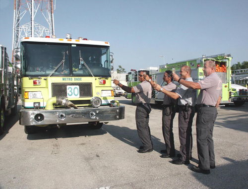 MDF 01820 - Station 30 crew toasts the old Engine 30 after changing out to the new Engine 30 (in the background). Pictured are (l to r) Driver/Engineer Clyde Porter, F/F Onelio Tam, F/F Heinrich Orth and Capt. Paul Gurdak.